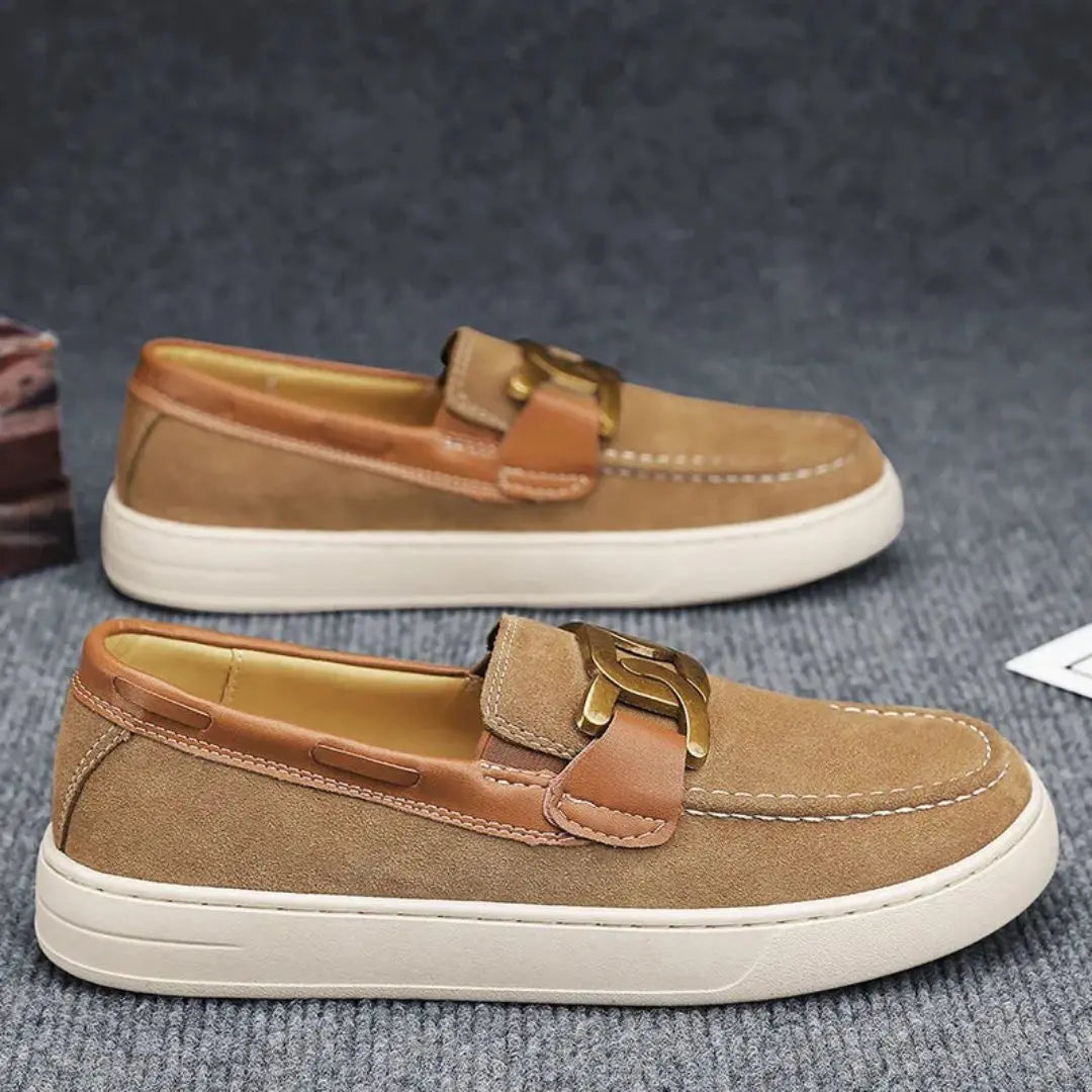 Men's brown leather slip-on loafers with gold-tone buckle accent, lightweight durable sole