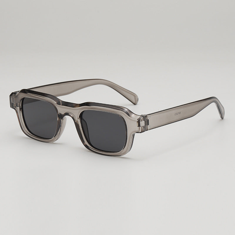 Black bold square sunglasses sleek high-gloss finish UV blocking lenses modern boxy silhouette