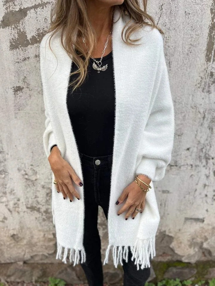 Women's long knit cardigan wrap with soft fringe trim, cozy plush texture, effortless layering style