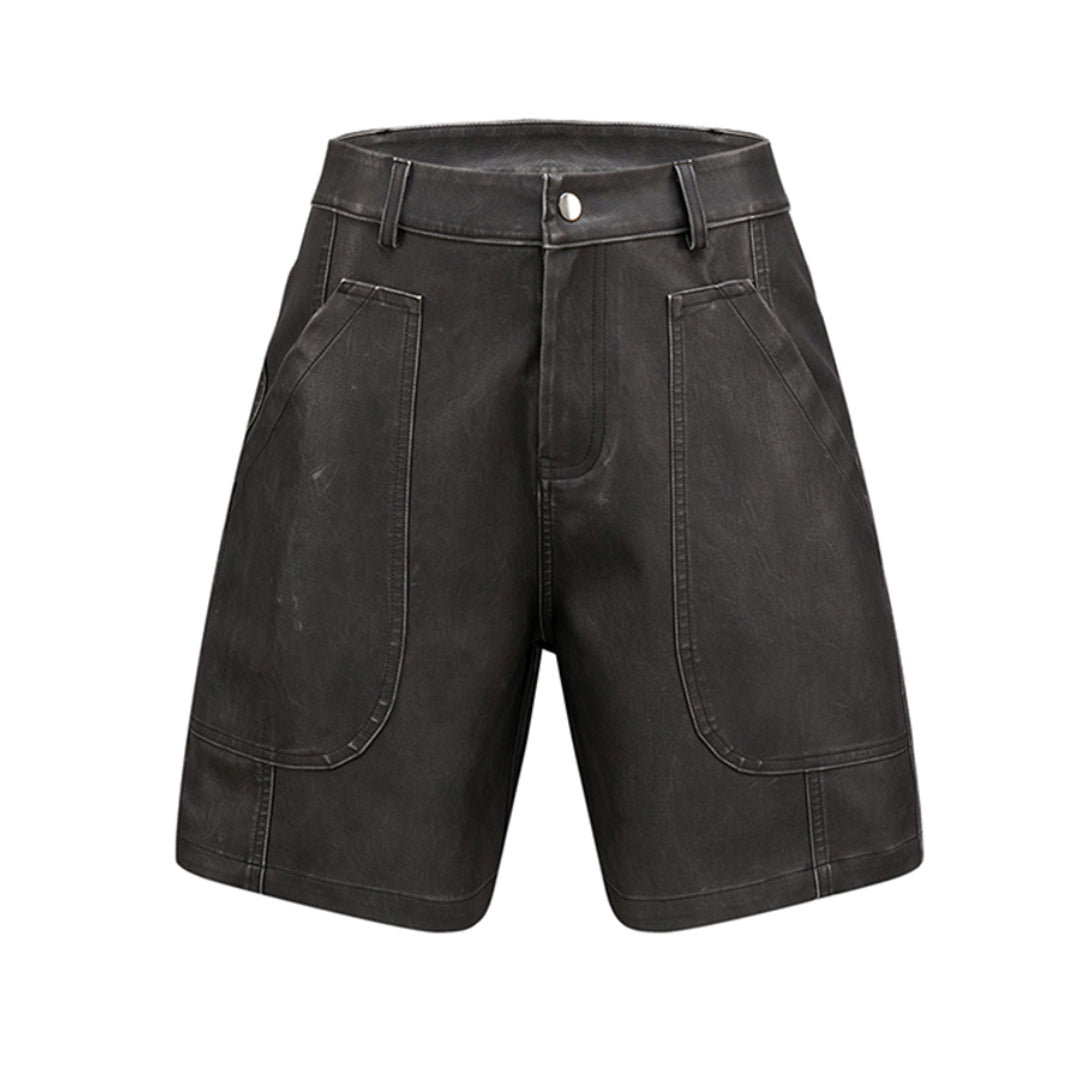 Black matte vegan leather knee-length shorts, loose mid-rise fit with paneled texture detail