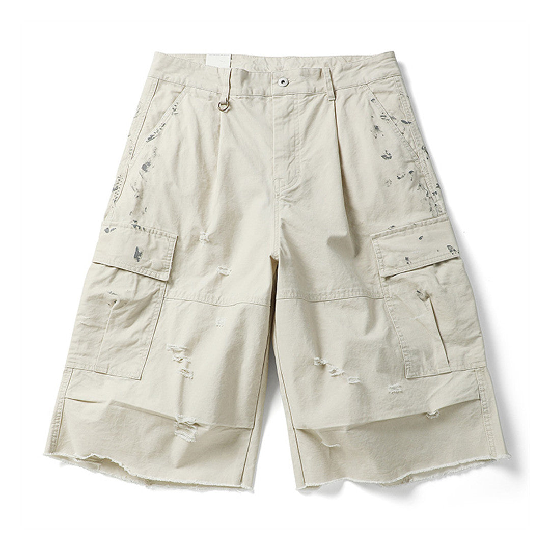 Men's oversized distressed cargo shorts with frayed raw hem edges and multi-pocket streetwear design