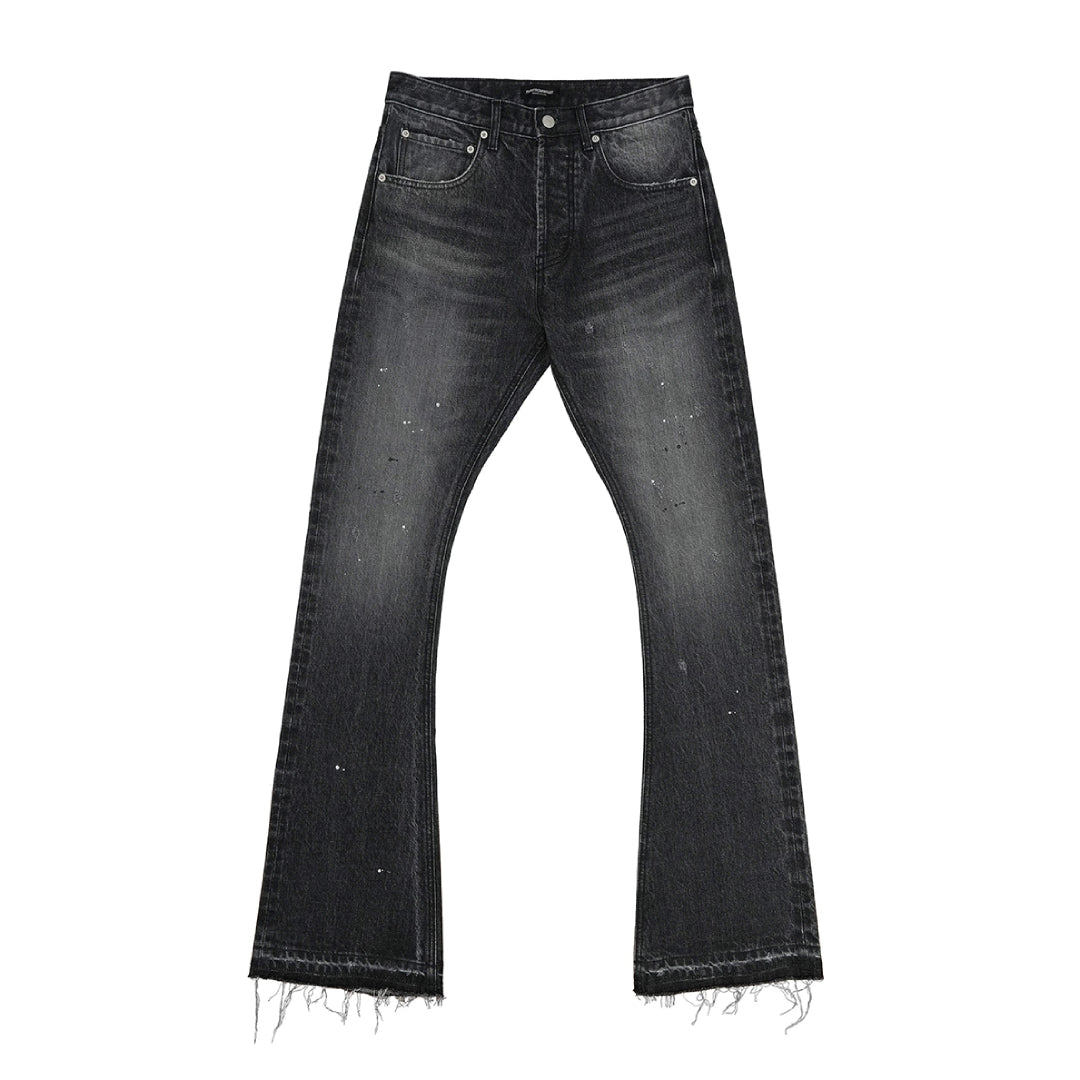 Women's blue bootcut flare jeans with ink splatter distressing, fading, and frayed hem