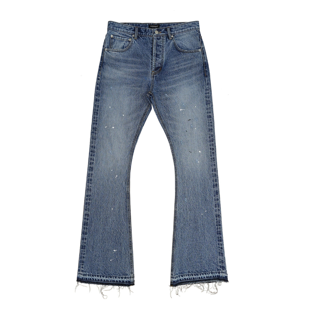 Women's blue bootcut flare denim jeans with ink splatter distressing, fading, and frayed hem
