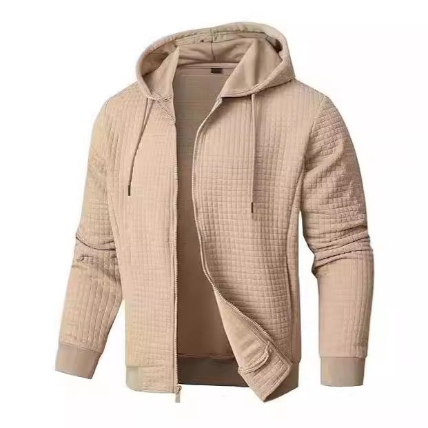 Men's navy quilted bomber jacket with hood, full-zip front, and waffle knit texture side pockets