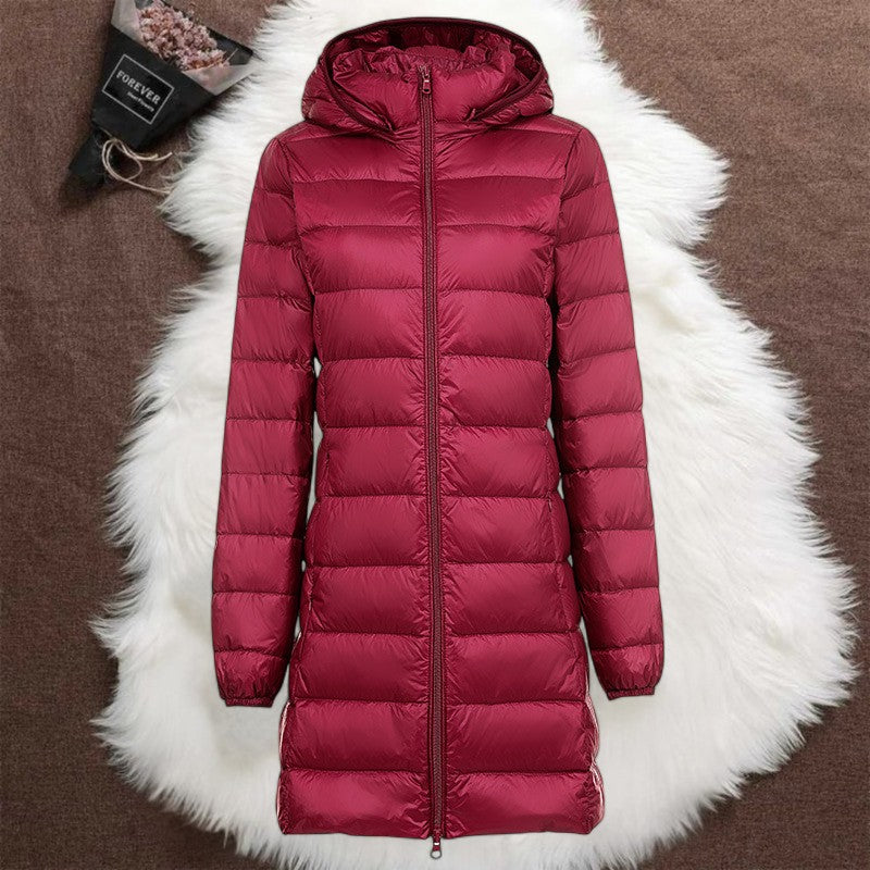 Longline quilted zip jacket with attached hood, sleek silhouette for everyday warmth and travel