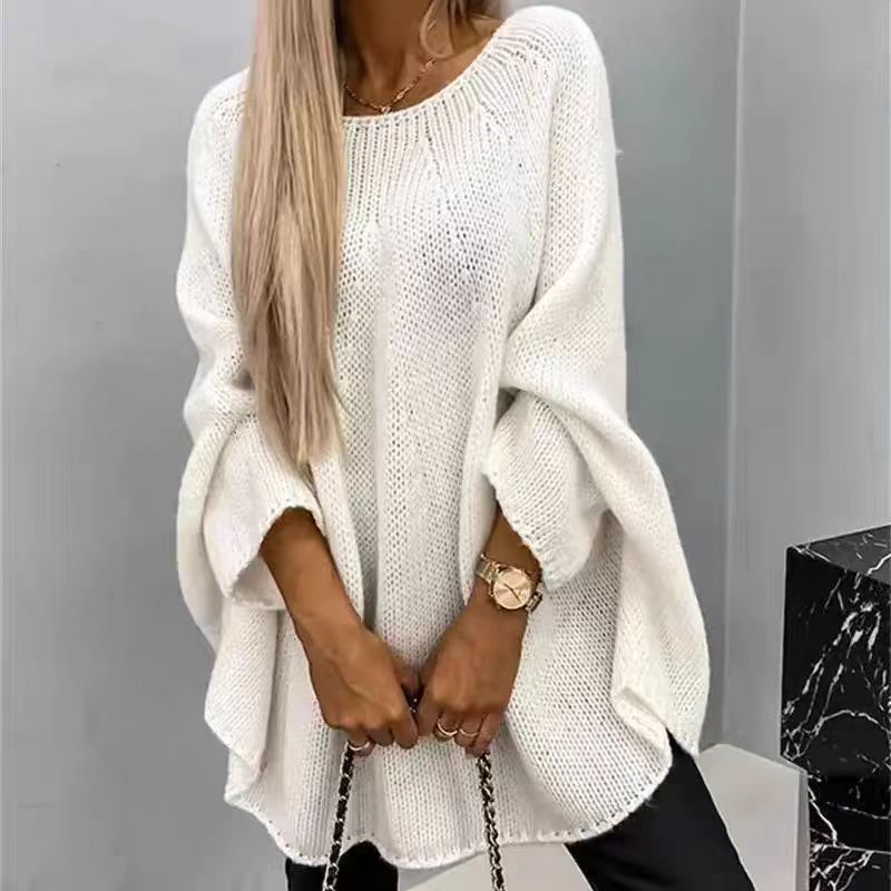 Women's loose-fit knitted sweater in soft warm tones, oversized cozy silhouette for winter layering
