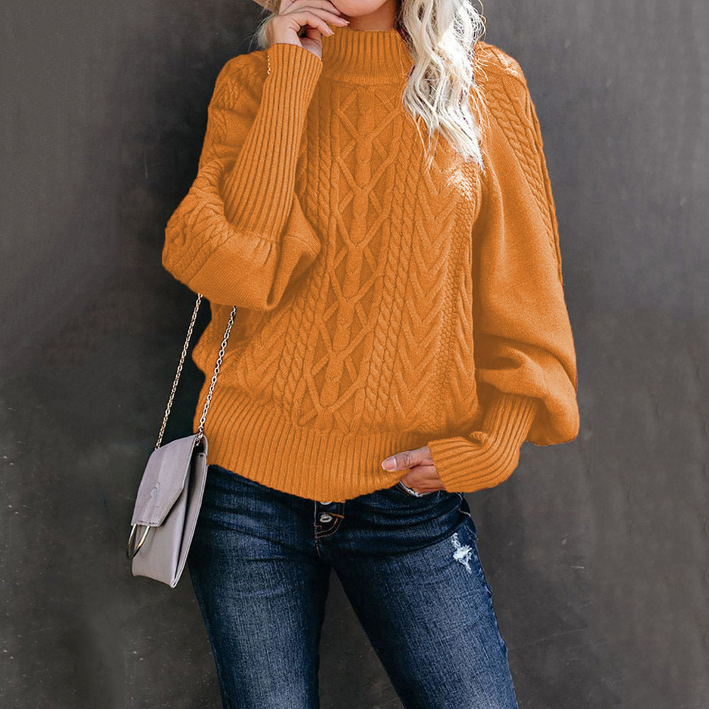 Women's chunky knit sweater in cozy neutral tones with high collar, voluminous sleeves, and hooded design