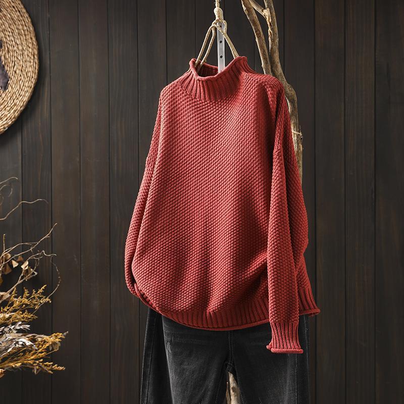 Cream waffle-knit turtleneck sweater with dropped shoulders and structured texture for relaxed layering