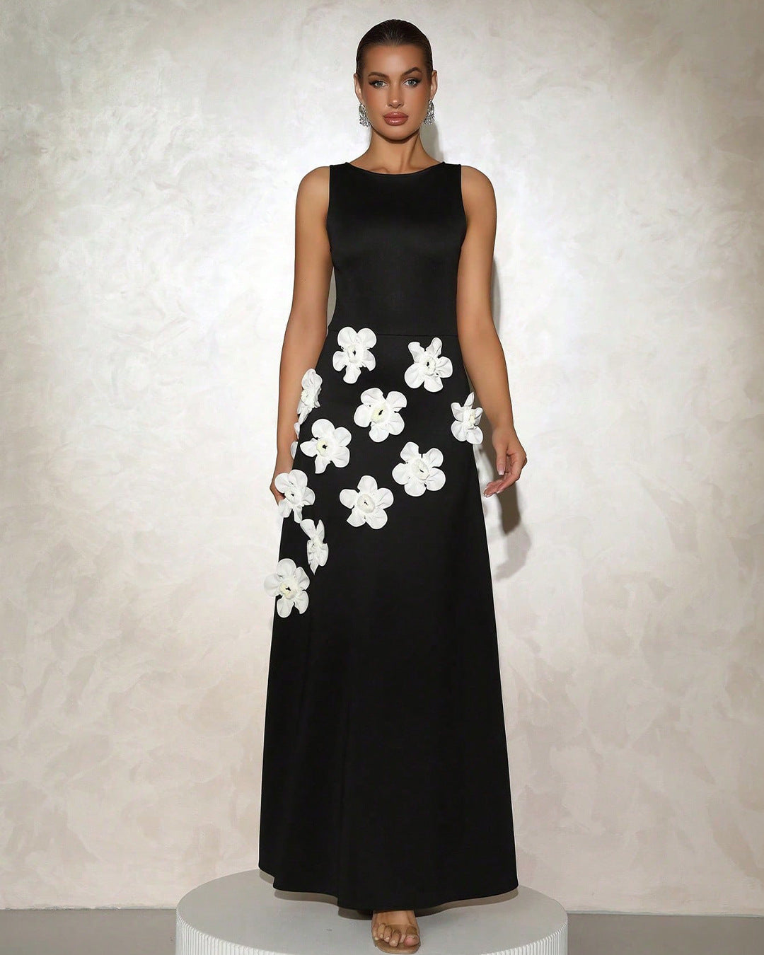 White sleeveless maxi gown with sculpted floral appliqué cascading skirt for brides and galas