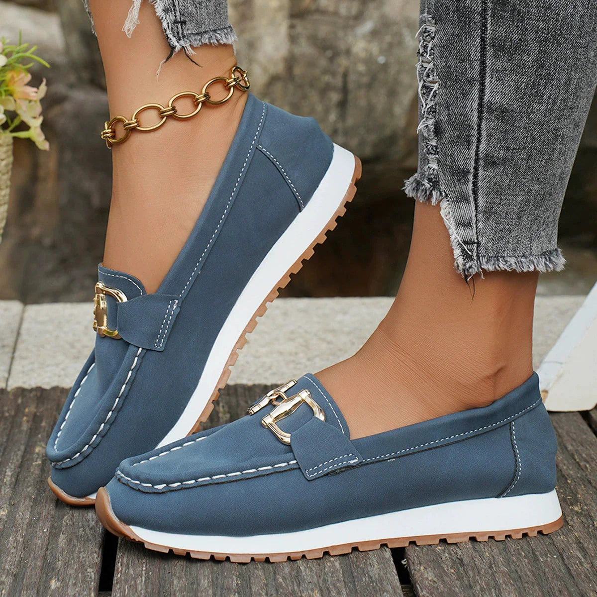 Women's suede-like loafers in neutral tone with classic silhouette and elegant gold buckle accent