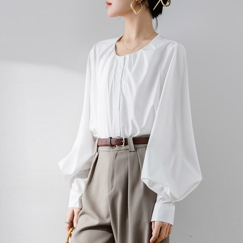 Women's loose-fit elegant blouse with lantern sleeves, round neck, and button closure for versatile styling