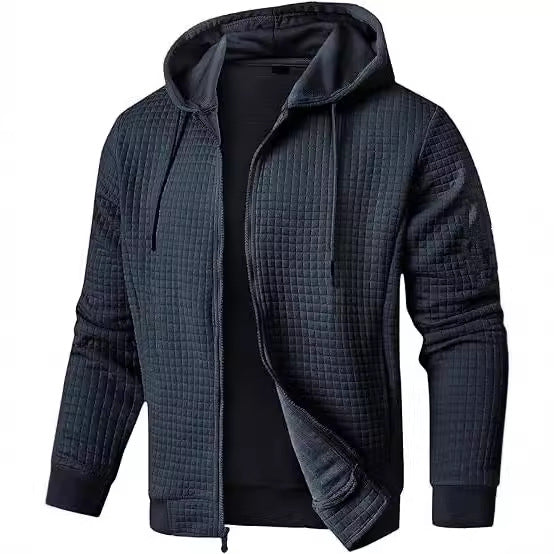 Men's navy quilted bomber jacket with hooded waffle knit texture and full-zip front pockets
