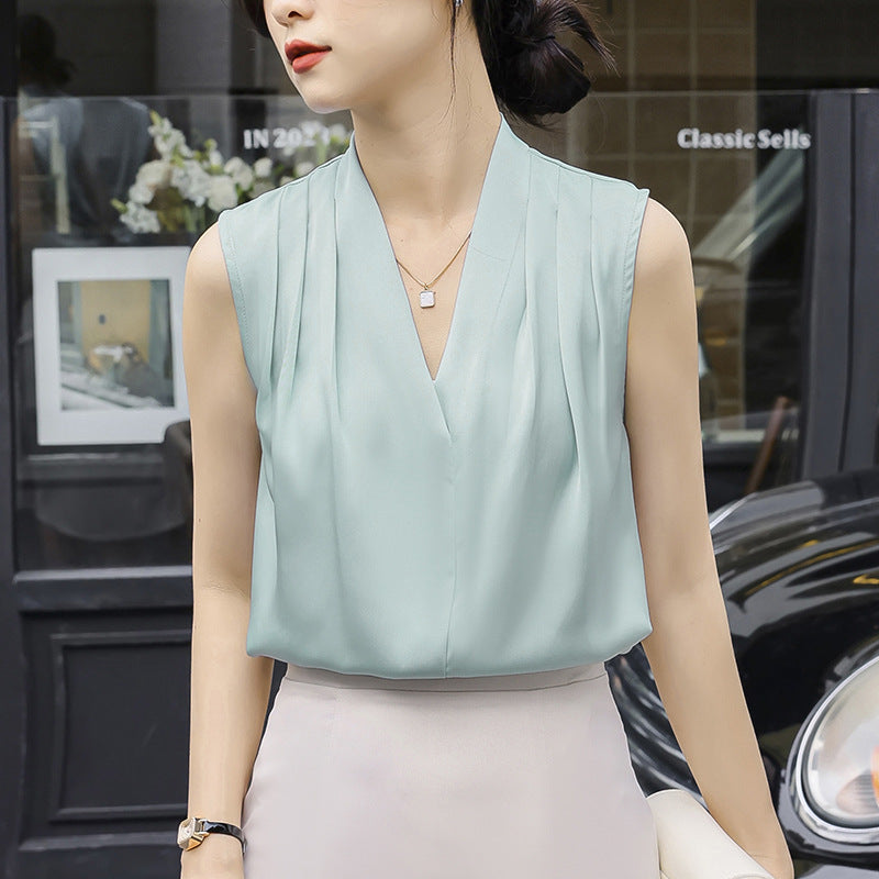Women's ivory satin pleated V-neck sleeveless blouse with soft wrap detail and subtle sheen