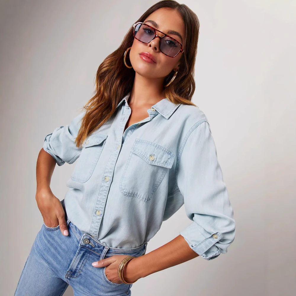 Women's relaxed fit denim shirt with button-front closure, long sleeves, and dual chest pockets
