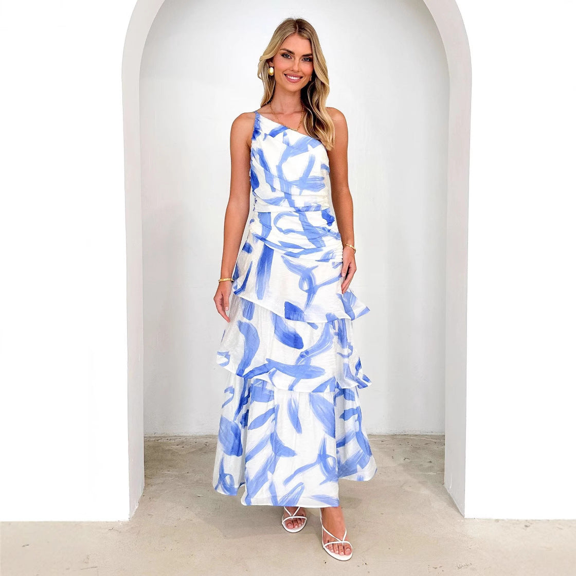 Black one-shoulder maxi dress with ruched bodice and tiered A-line skirt, elegant festive summer style
