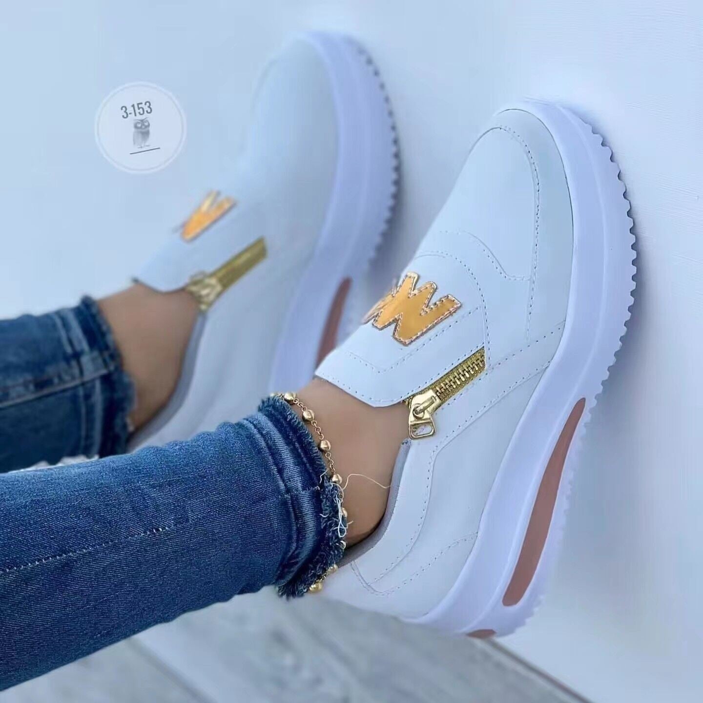 Women's low-top sneakers with suede panels, gold zipper accent, and thick comfort sole