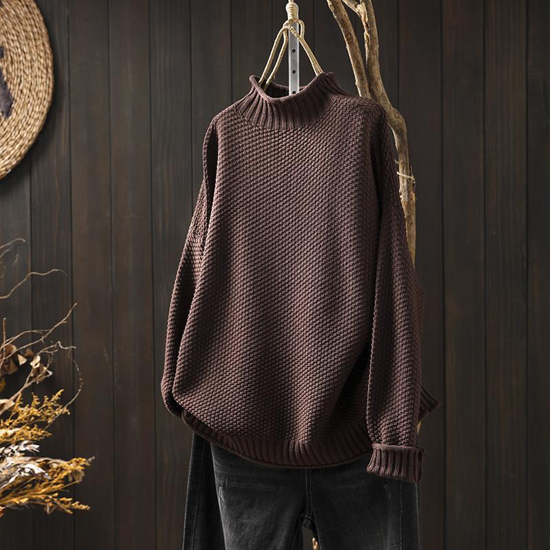 Cream waffle-knit turtleneck sweater with dropped shoulders and structured texture for relaxed layering
