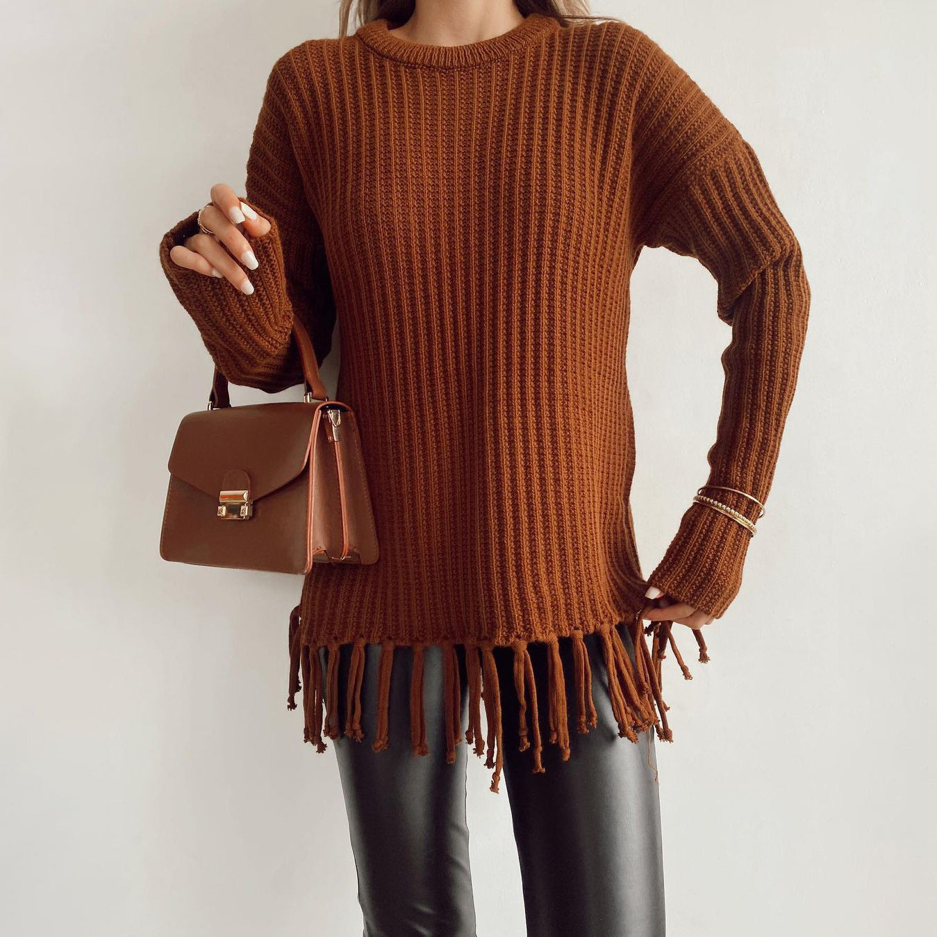 Women's oversized chunky wool knit pullover sweater with fringe hem, relaxed cozy fall style