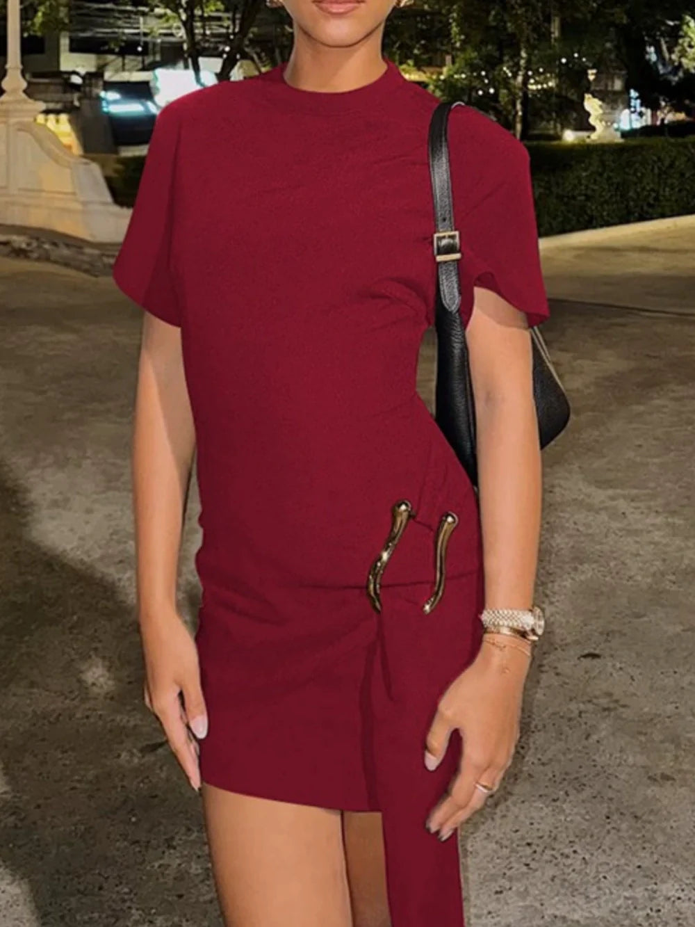 Black ponte knit mini dress figure-skimming silhouette with draped detail and statement hardware belt