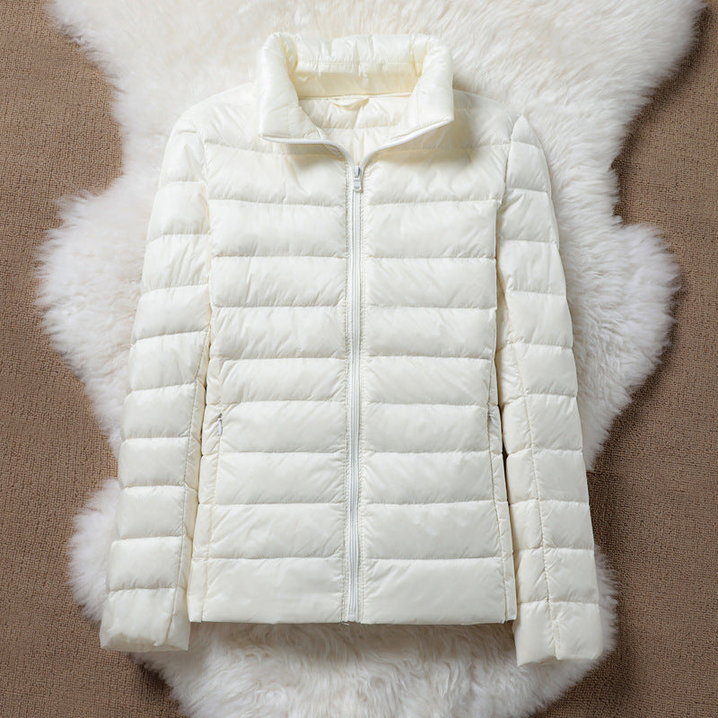 Lightweight quilted zip jacket in neutral tone, slim modern cut with full-front zipper for everyday warmth