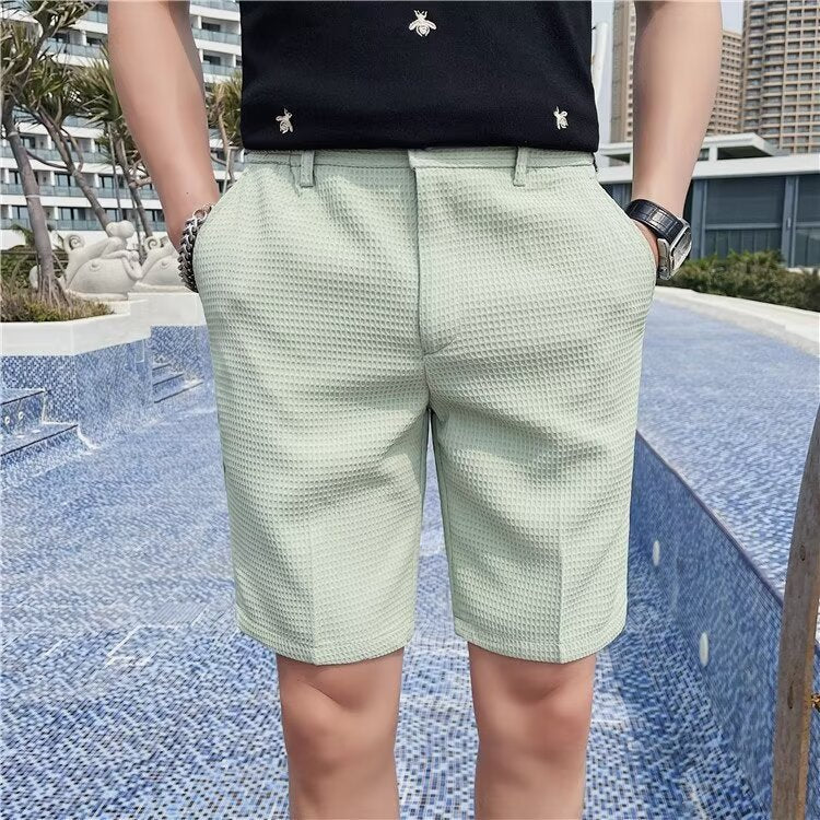 Men's slim fit knee-length shorts with buttoned waist and belt loops in casual tailored style