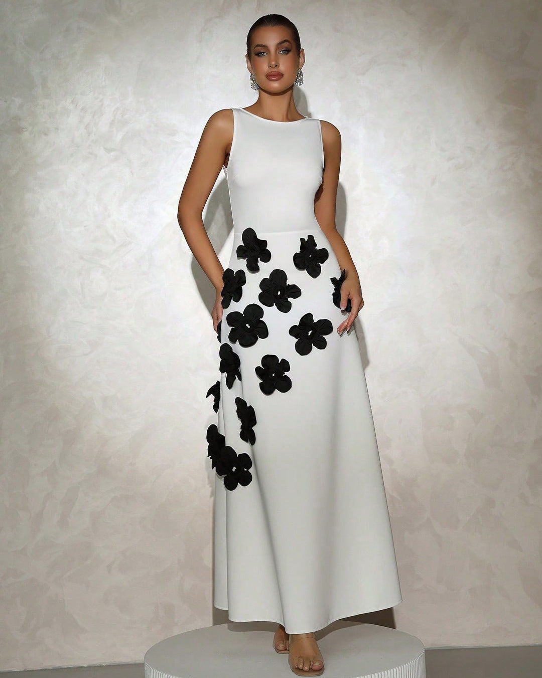 White sleeveless maxi gown with sculpted 3D floral appliqué cascading skirt for brides and galas
