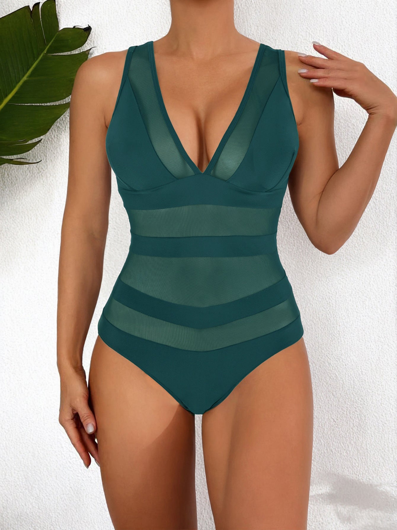 Women's form-fitting one-piece swimsuit deep V-neck mesh panel high-cut leg sleek beach style