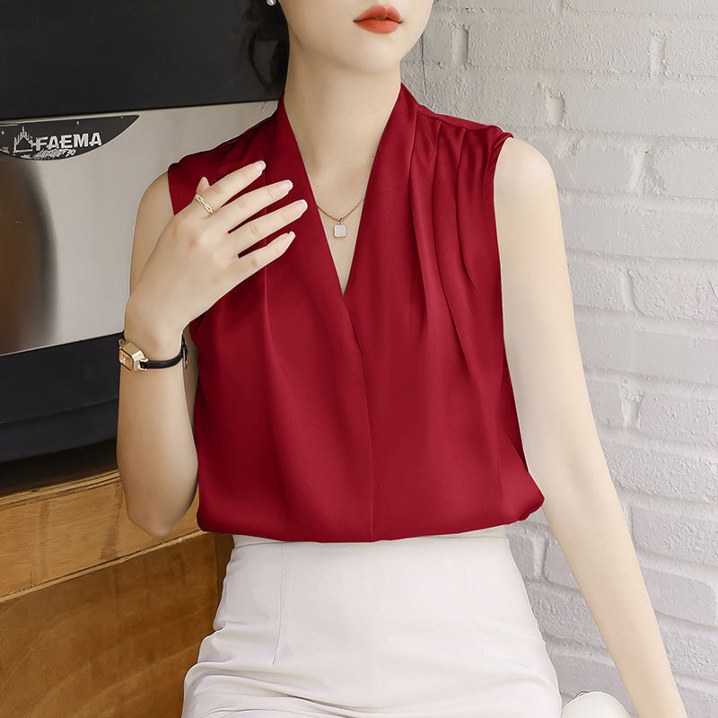 Women's ivory satin sleeveless V-neck blouse with pleated wrap detail and flowy silhouette