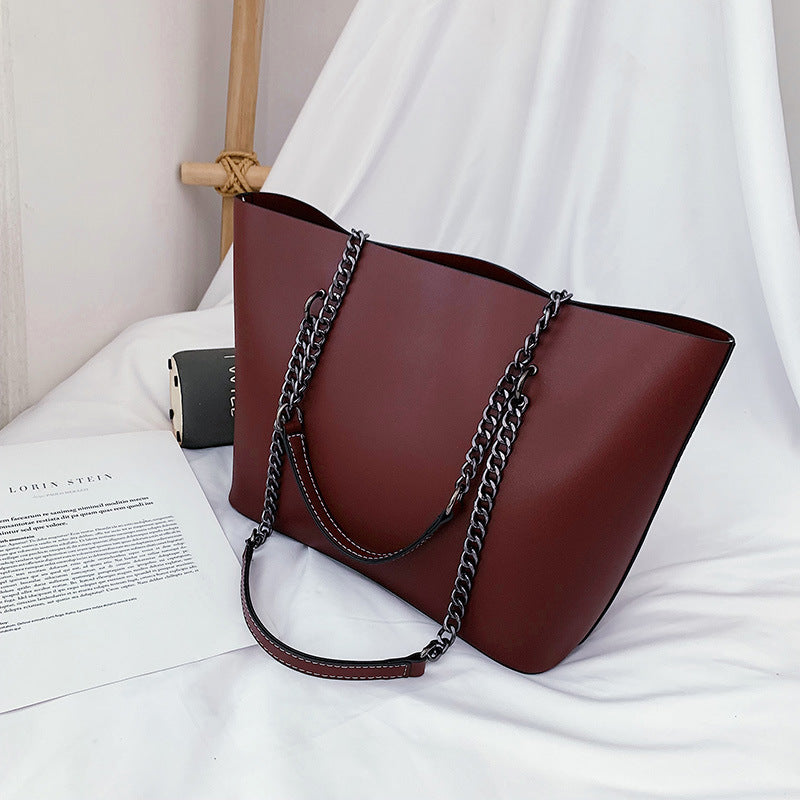 Structured vegan leather tote shoulder bag with gold chain strap, spacious interior, polished everyday style