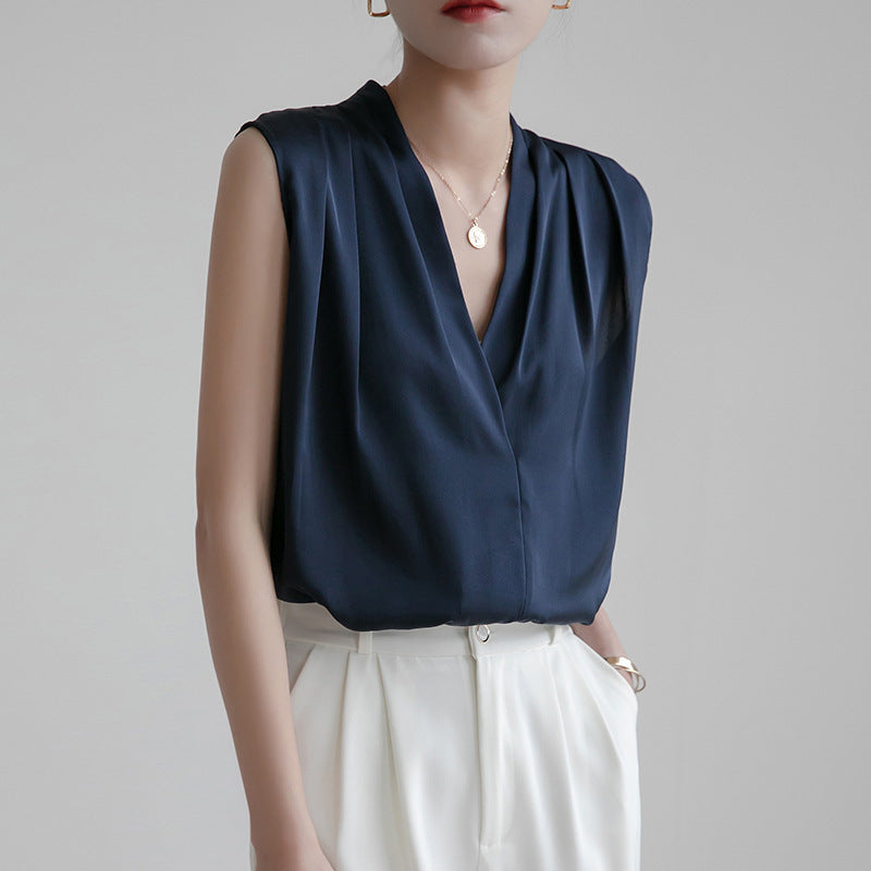 Ivory satin sleeveless blouse deep V-neck pleated wrap front flowy silhouette office-ready