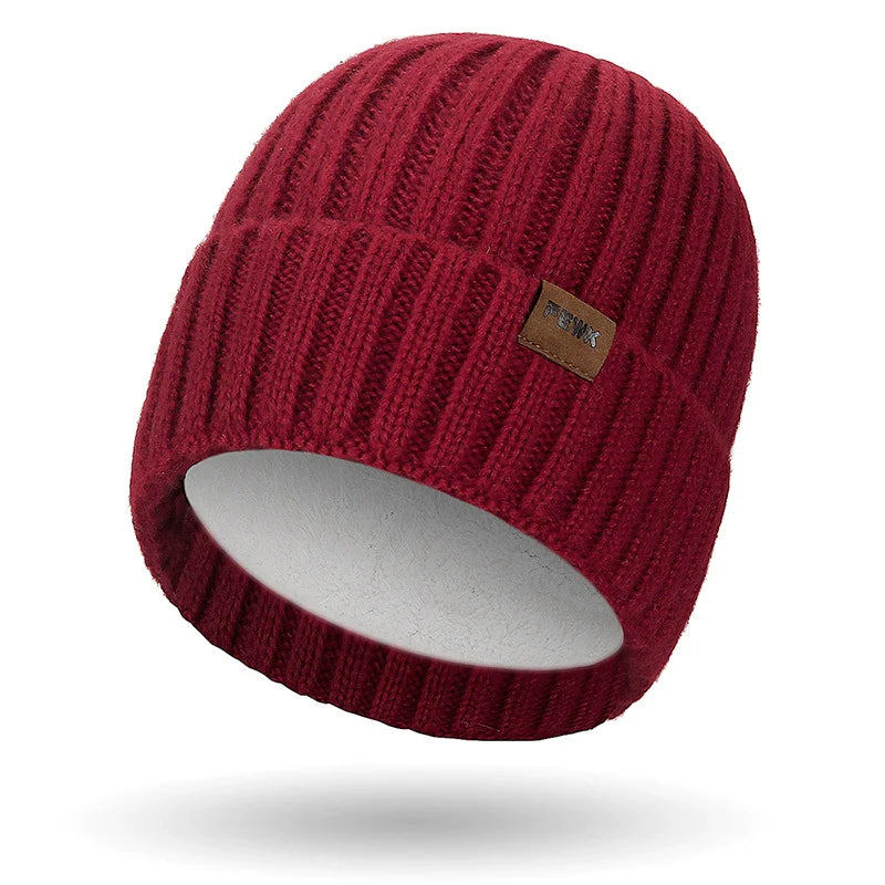 Dark knit unisex beanie with fold-over ribbed cuff and subtle stitched patch for casual everyday wear