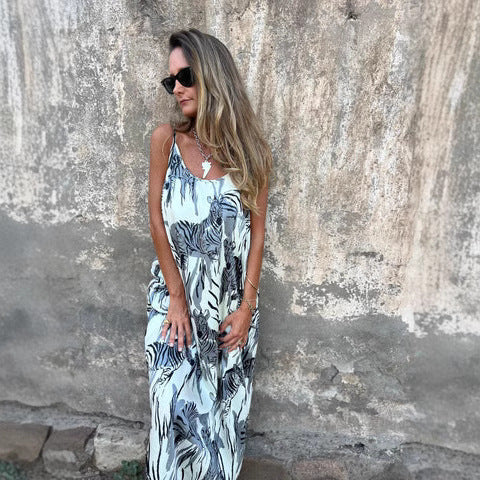 Women's flowy maxi dress with adjustable straps, relaxed silhouette, and functional side pockets