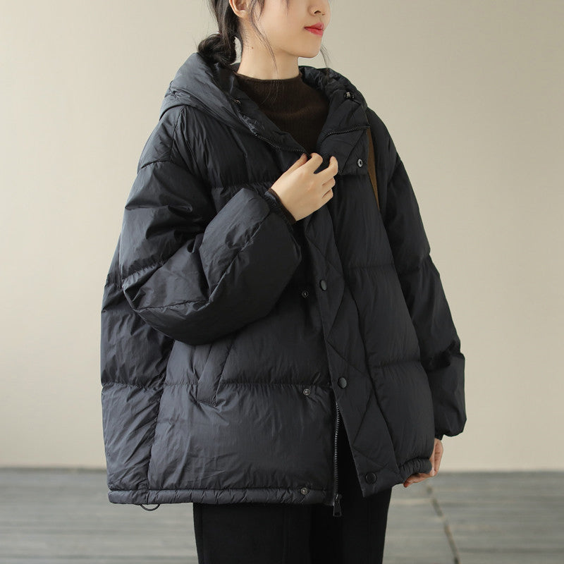 Women's black hooded quilted puffer jacket with premium insulation and chic winter silhouette