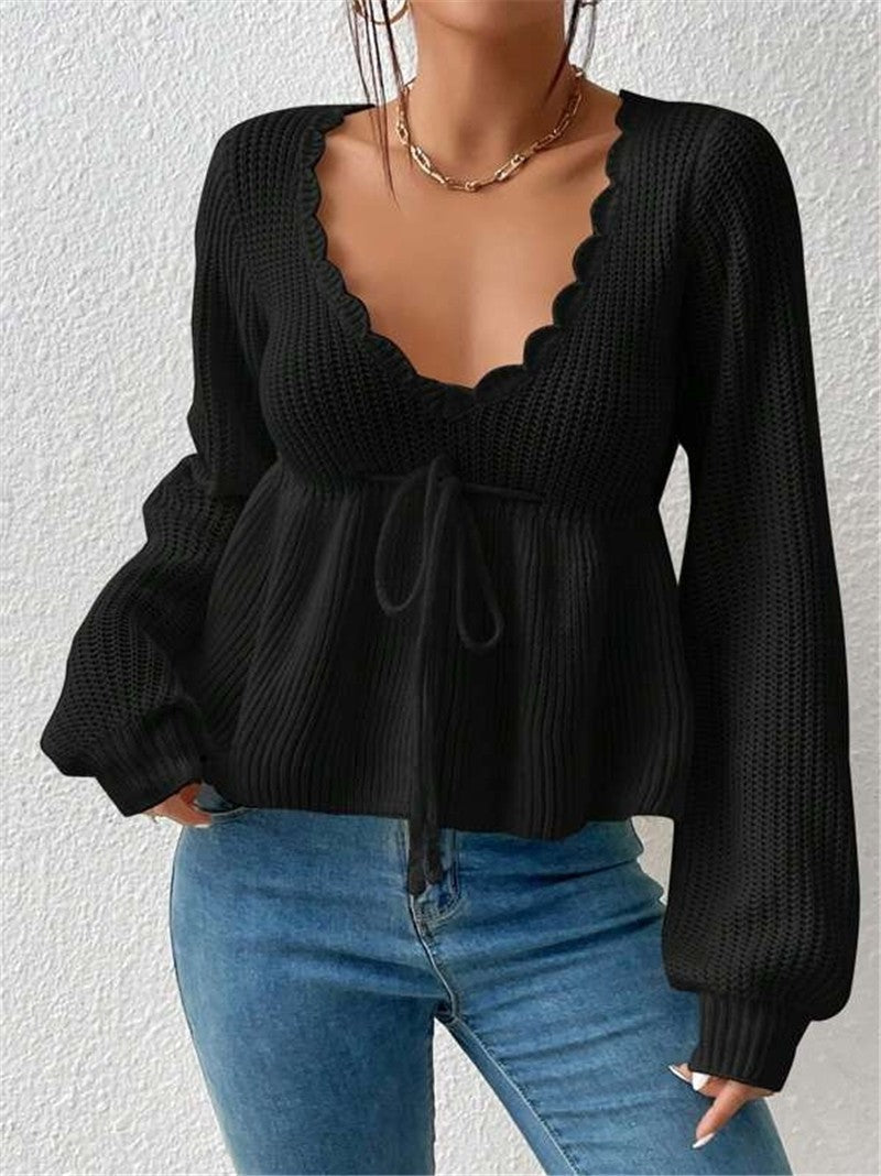 Women's ribbed knit pullover sweater with drawstring waist and feminine ruffled hem detail