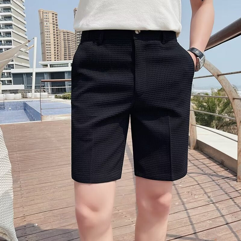 Men's slim fit knee-length shorts with buttoned waist and belt loops in casual tailored style