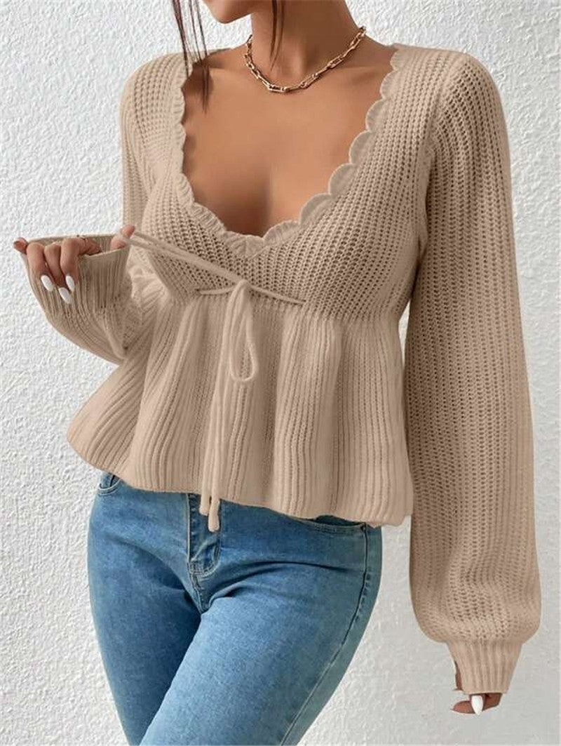 Women's ribbed knit pullover sweater with drawstring waist and feminine ruffle detail
