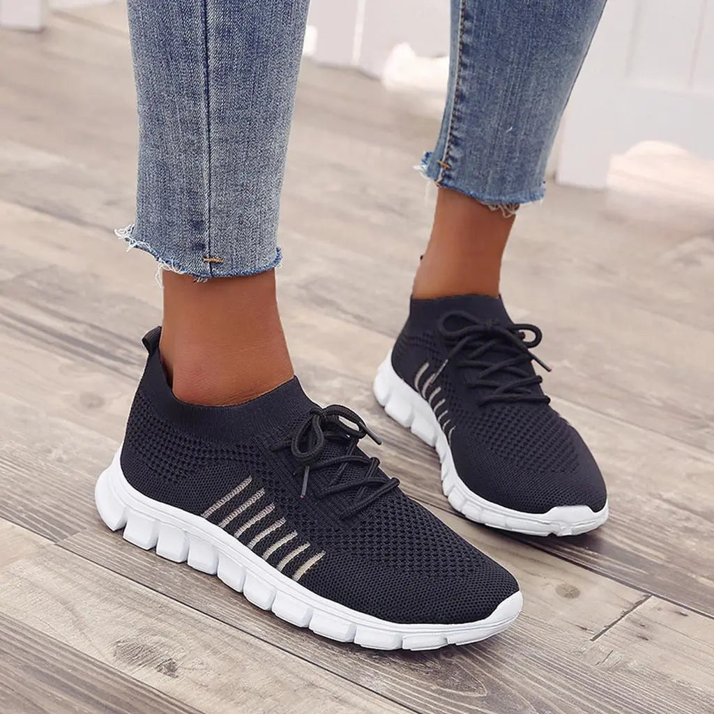 Women's white comfort sneakers with gel sole cushioning, adaptive fit, and sleek modern design for all-day stability