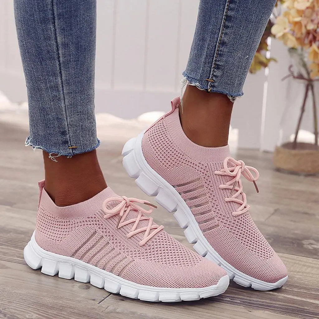 Women's white comfort sneakers with gel sole cushioning, adaptive fit, and modern low-top silhouette