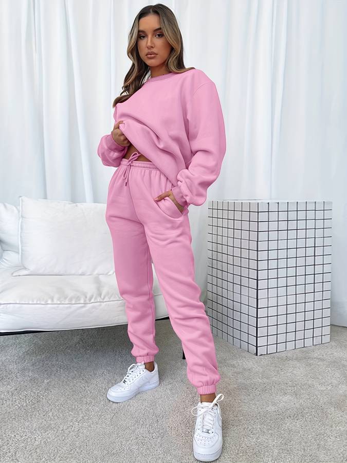 Pink oversized women's two-piece sweat set with loose pullover and elastic drawstring joggers