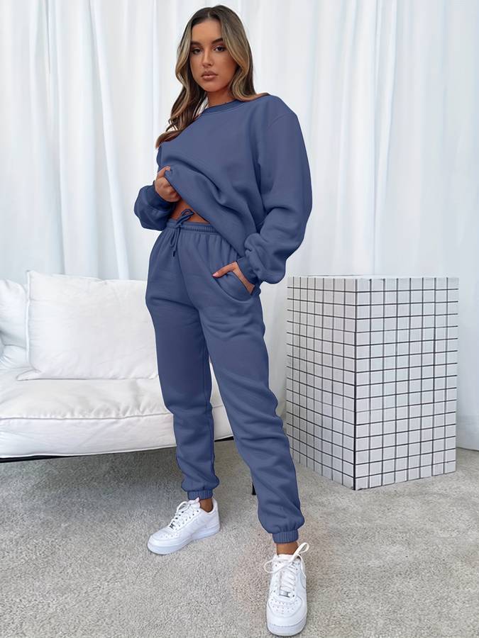Pink oversized women's two-piece sweat set with loose pullover and elastic drawstring joggers