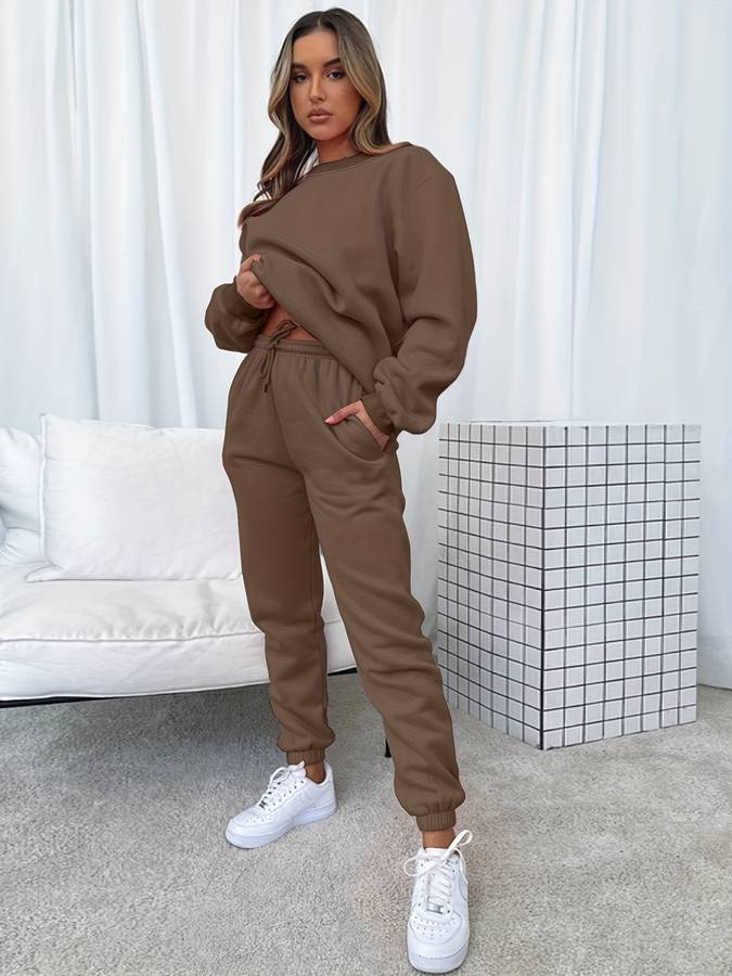 Pink oversized women's two-piece sweat set with loose pullover and elastic drawstring joggers