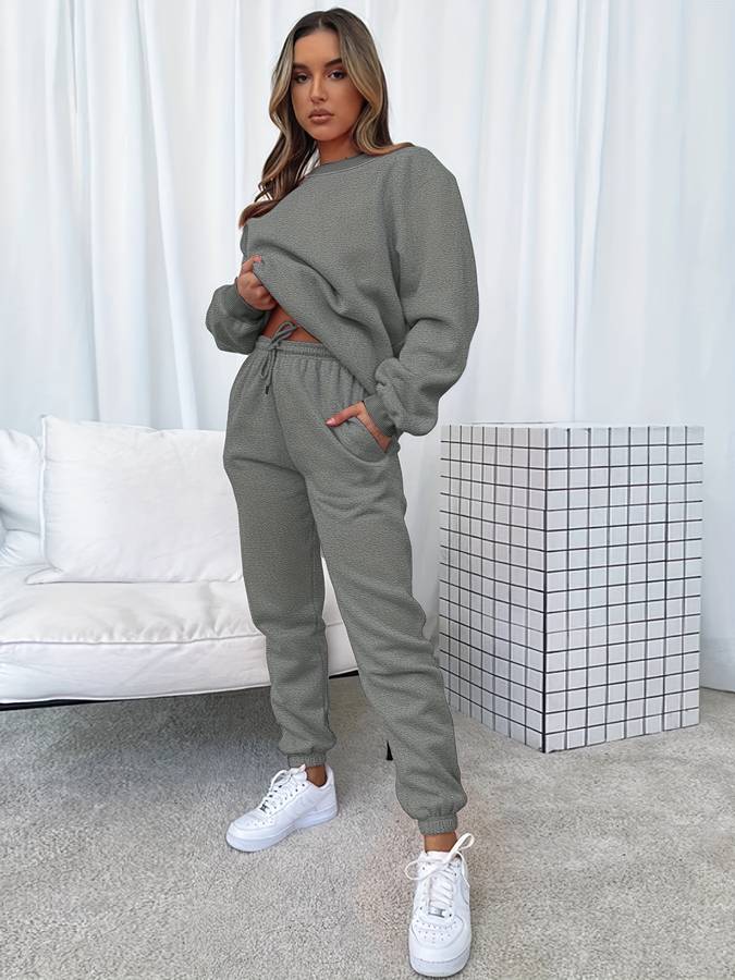 Pink oversized women's two-piece sweat set with loose pullover and drawstring elastic joggers
