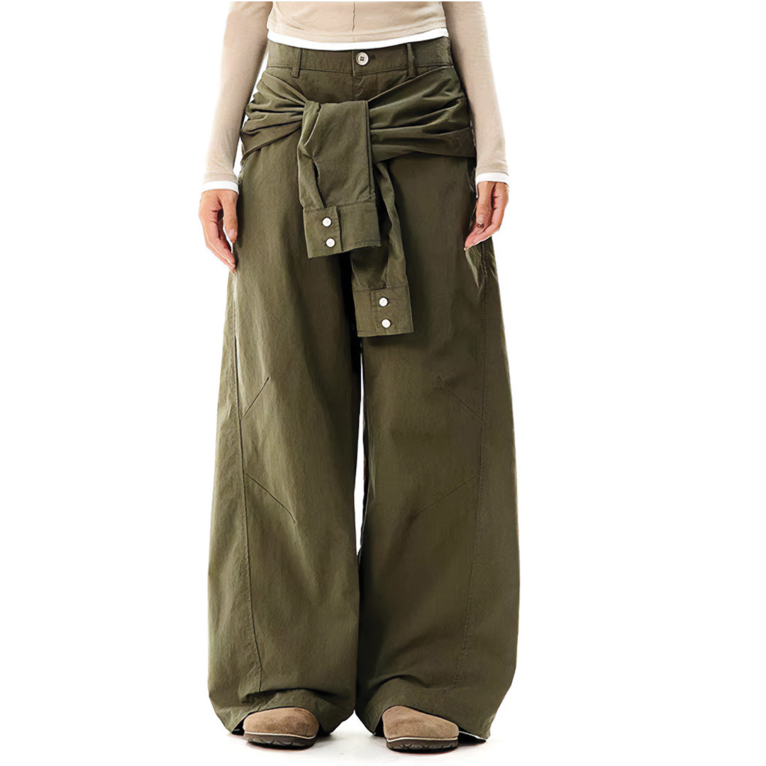 Black minimalist trousers with attached hanging sleeves at waist, loose straight-leg avant-garde design