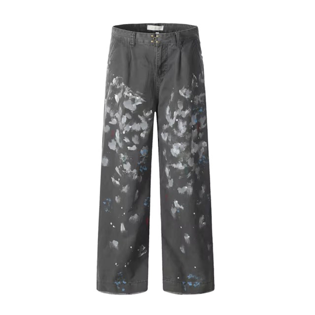 Black cotton loose straight-leg trousers with bold paint splatter and distressed artist-inspired details