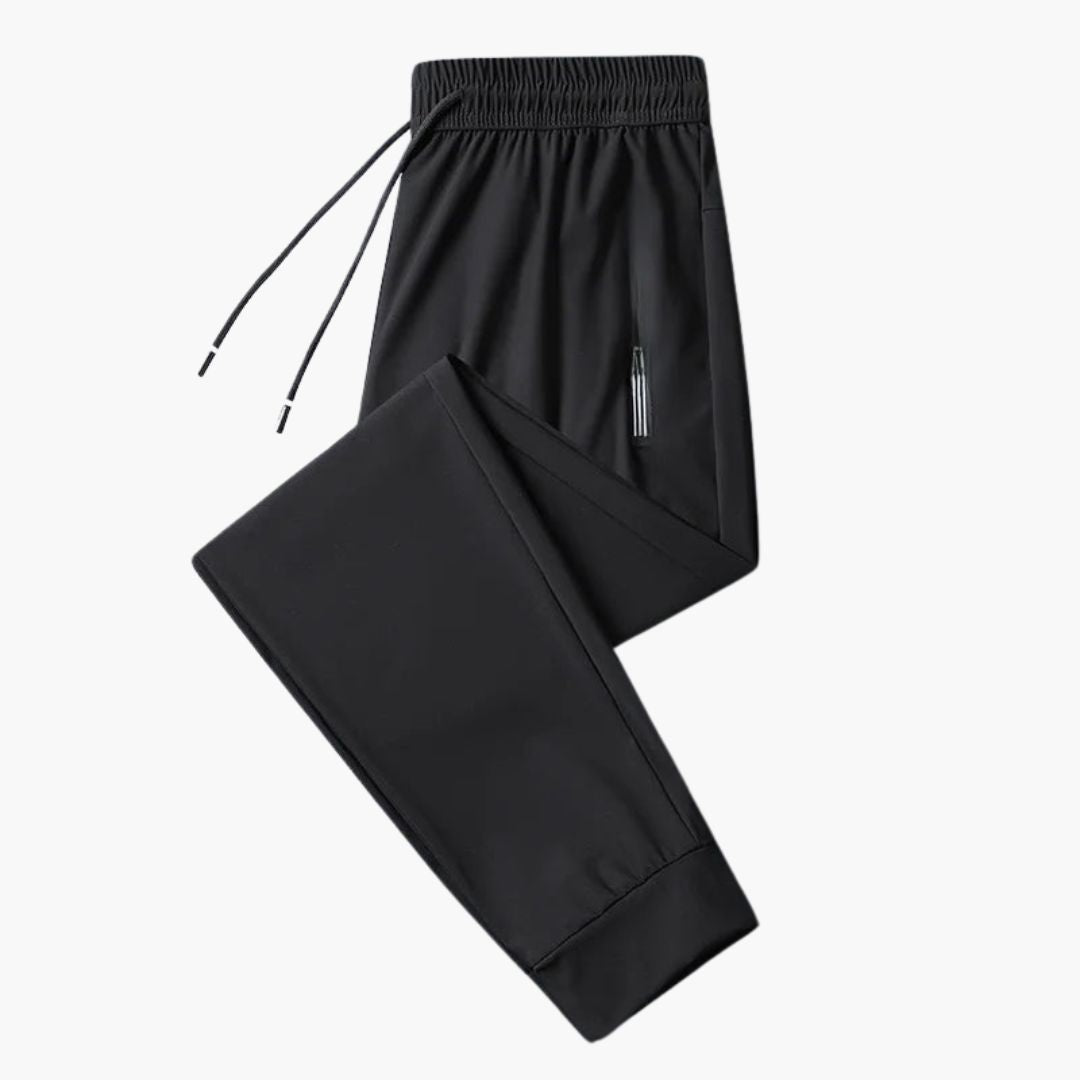 Men's gray jogger pants with elastic waistband, tapered fit, and secure zipped pockets for active wear