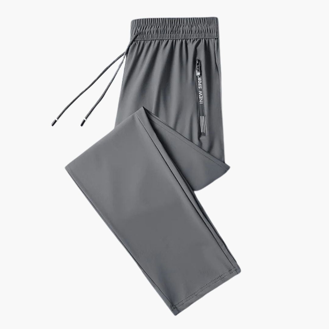 Men's gray jogger pants with elastic waistband, tapered fit, and secure zipped pockets for active wear