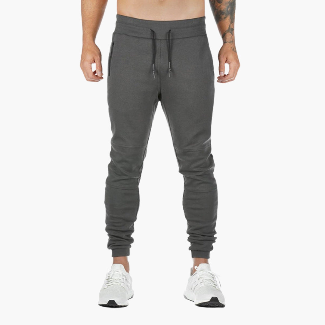 Men's tapered athletic joggers with elastic drawstring waist and zippered pockets for active wear