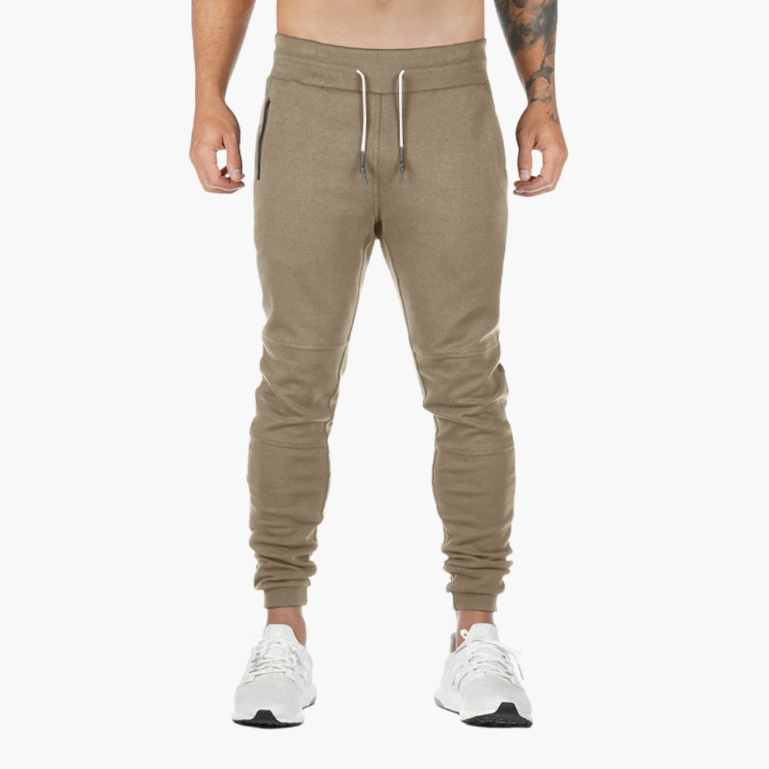 Men's tapered jogger pants in solid color with elastic drawstring waistband and zippered pockets