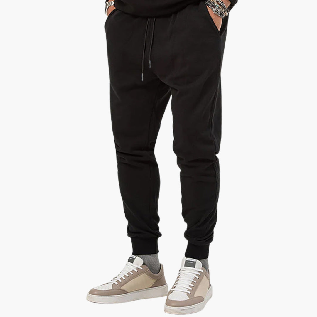 Men's tapered athletic joggers with elastic drawstring waist, side pockets, and pull-on cuffed ankles