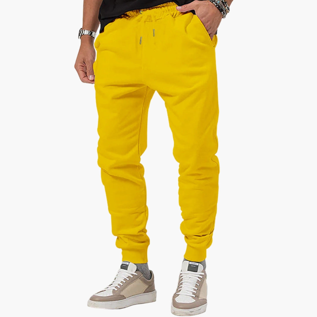 Men's tapered athletic joggers with elastic drawstring waist, side pockets, and pull-on cuffed ankles